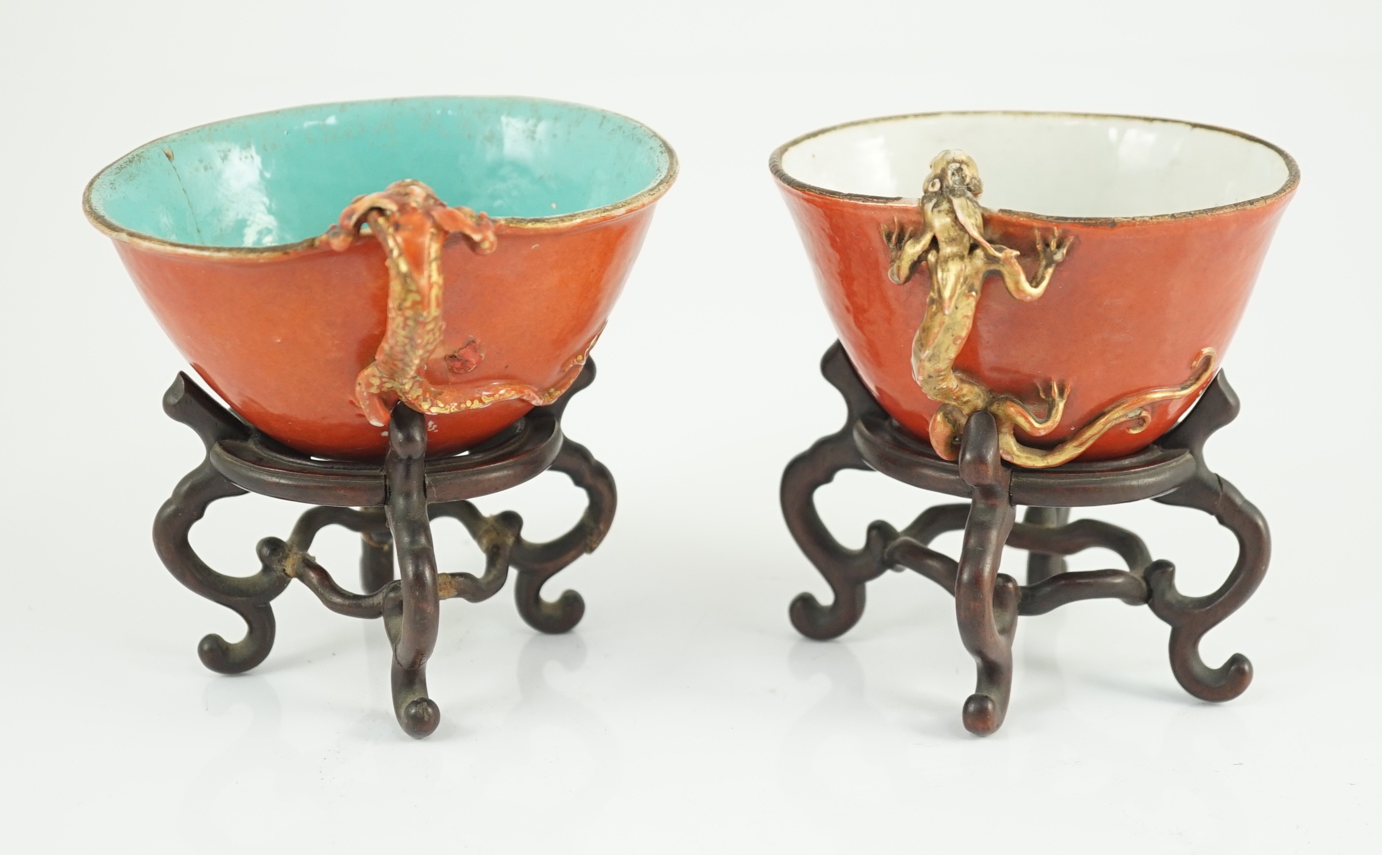 Two similar Chinese coral ground libation cups, late 18th/early 19th century, 10.5cm and 11.5cm across, wood stands